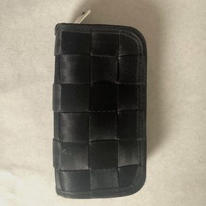Harveys Seatbelt classic black wallet, zip close, accordion style.